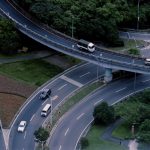 Aerial view of a busy urban intersection with multi-level roads and traffic.