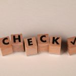 Verifiable tinyML Simulators for Resilient Urban Systems Wooden blocks aligned to spell 'CHECK' with a checkmark symbol on a neutral background.