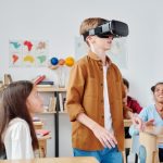 Virtual Reality in Education: The Operational Barriers to Scale Children engaged with virtual reality headsets in a vibrant classroom setting, exploring immersive technology.