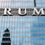 Why Behavioral Architecture Trumps Willpower in Health Optimization Close-up of Trump Tower's glass facade with the city skyline reflection in the windows.