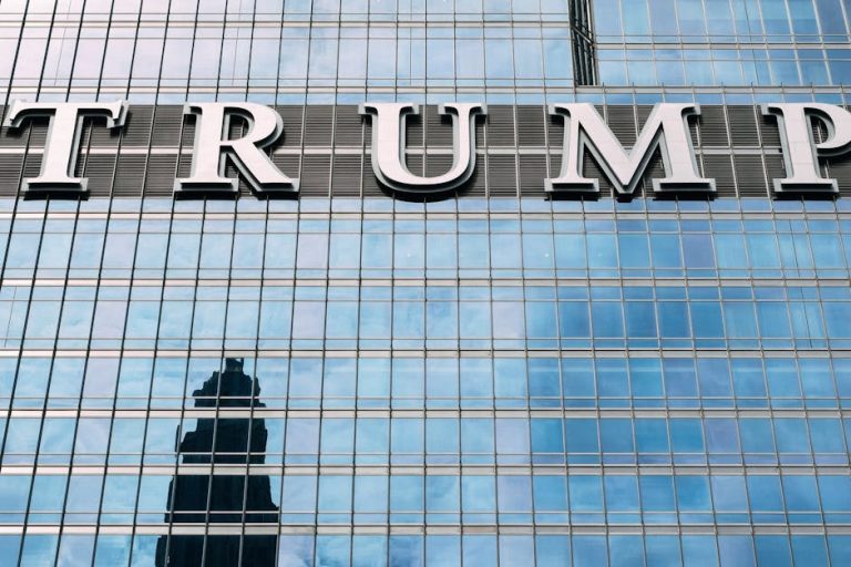 Close-up of Trump Tower's glass facade with the city skyline reflection in the windows.