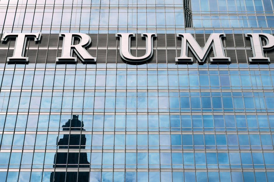 Close-up of Trump Tower's glass facade with the city skyline reflection in the windows.