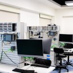 A contemporary computer lab with advanced workstations and electronic equipment, perfect for research and development.