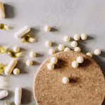 Why Modern Medicine Is Essential for Ecological Sustainability A mix of various capsules and pills scattered on a cork surface, depicting healthcare and wellness.