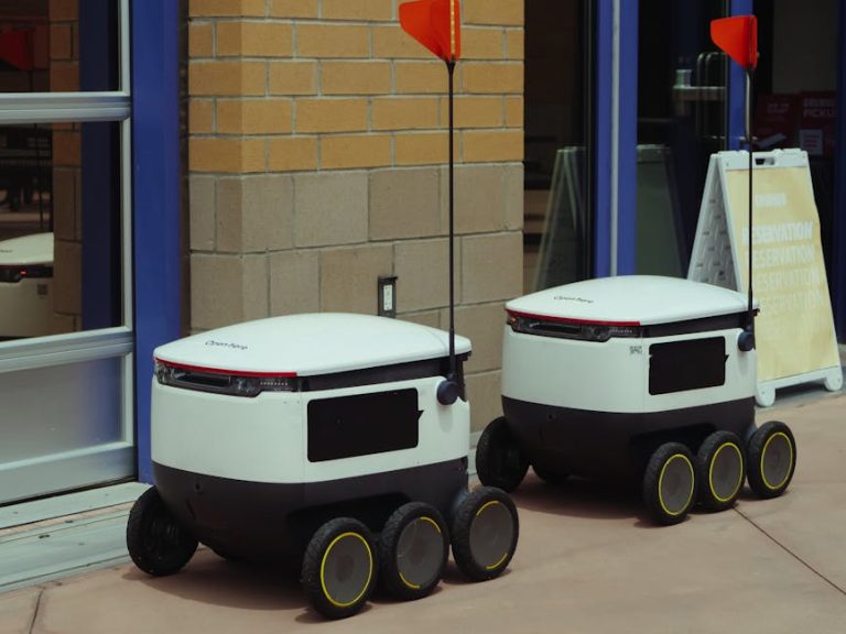 Autonomous delivery robots outside building ready for modern food service.