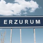 <h1>Zero-Shot In-Situ Resource Utilization (ISRU) Simulators: The Future of Urban Circularity</h1> Street sign for Erzurum against a backdrop of a bright blue sky and fluffy clouds.