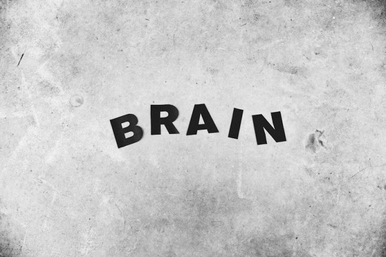 Black and white backdrop of Brain title with highlighted letters on gray wall with rough surface