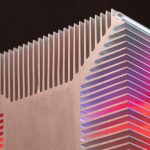 Abstract view of an aluminum heat sink with colorful lighting, showcasing modern technology.