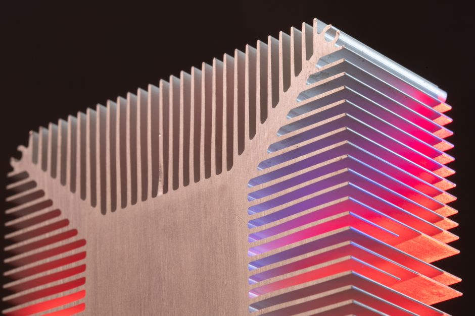 Abstract view of an aluminum heat sink with colorful lighting, showcasing modern technology.