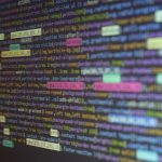 Close-up of colorful source code on a monitor, showcasing programming and technology concepts.