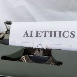 AI in Business: Why Algorithms Lack Consciousness and Strategy Close-up of vintage typewriter with 'AI ETHICS' typed on paper, emphasizing technology and responsibility.