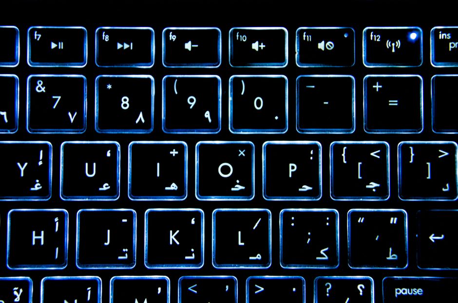 Detailed view of a backlit keyboard with Arabic numerals and symbols.