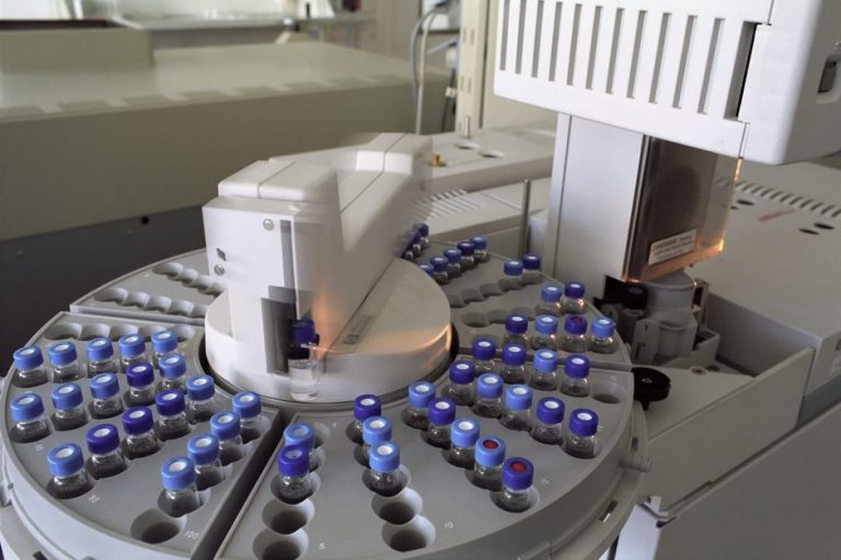 High-tech laboratory equipment with multiple vials in a scientific research facility.
