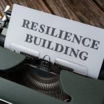 Beyond Resilience: The Antifragile Advantage in Business Ecosystems A vintage typewriter with the words 'RESILIENCE BUILDING' on a paper sheet.