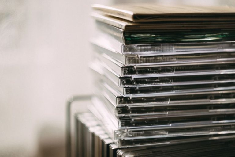 A stack of transparent CD cases neatly aligned, creating a still life composition.