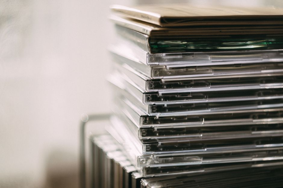 A stack of transparent CD cases neatly aligned, creating a still life composition.