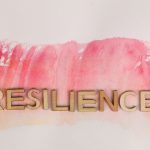 Beyond Resilience: Turning Climate Adaptation into a Market Moat Wooden letters spelling 'resilience' on pink watercolor background, creative typography.