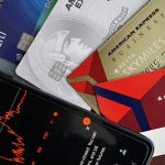 Beyond the Credit Gap: Why ‘Permissionless Innovation’ is a Leadership Trap Image showing credit cards and a financial market graph on a smartphone.