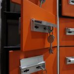 Orange lockers with metal keys highlighted in an indoor setting.