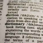 Beyond Translation: The Liability of Linguistic Homogeneity in Clinical AI Detailed close-up view of a dictionary page highlighting the word 'dictionary' and its definition.