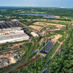 Aerial view of a large industrial complex surrounded by greenery in Bohumín, Czech Republic.