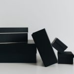 Black Box Liability: Why Algorithmic Transparency Matters A minimalist display of black gift boxes of varying sizes against a white background.