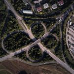 Aerial shot of a complex highway intersection in Veszprém, Hungary, showcasing urban landscape.