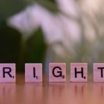 Cognitive Sovereignty: Ethics for High-Performance Leadership Wooden Scrabble tiles spelling 'Right' on a wooden surface with blurred background.