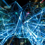 Collective Intelligence: How to Build High-Performance Teams Dynamic urban scene showcasing interconnected light trails representing digital communication networks.