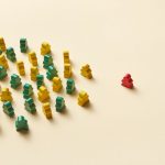 Combating Organizational Entropy: Strategies for Alignment Arrangement of colorful game pieces on a light yellow background creates a striking contrast.