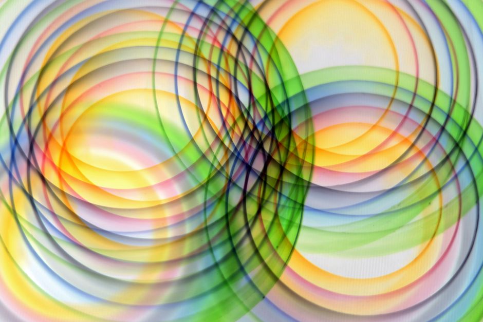 Vibrant overlapping circles create a colorful abstract pattern, radiating dynamic energy.