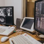 Deep Learning Diagnostics: Scaling Precision in Healthcare Medical imaging setup with MRI scans on multiple screens in a healthcare facility.