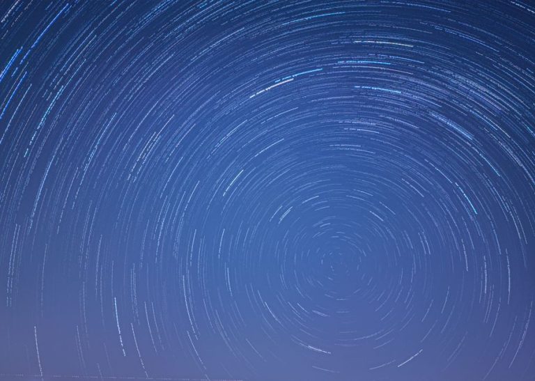 Long exposure image capturing mesmerizing star trails swirling in a clear night sky.