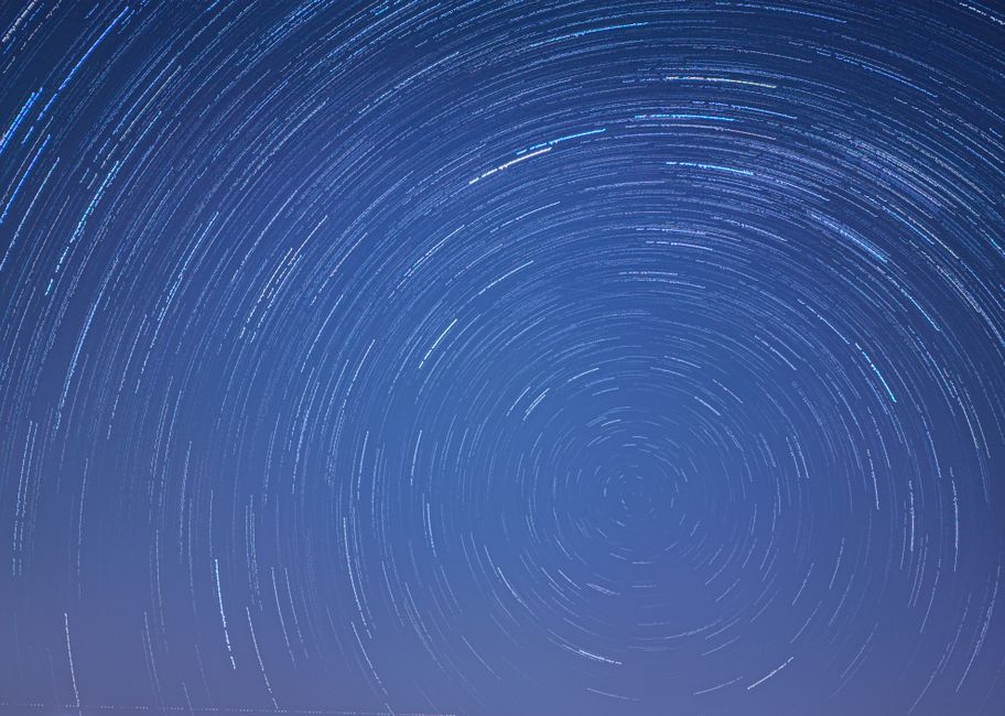 Long exposure image capturing mesmerizing star trails swirling in a clear night sky.