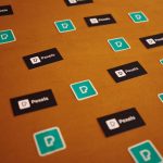 Digital Identity Strategy: Building Operational Trust at Scale Pexels logos and stickers scattered on a brown background in a creative pattern.