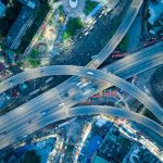 Digital Infrastructure Resilience: Strategy for Modern Growth Dynamic aerial shot of a bustling city highway intersection at night.