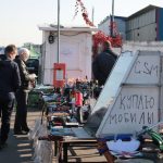 Digital Sovereignty: Why Vendor Lock-in Kills Your Business People browsing electronics at an outdoor market with various gadgets on display.