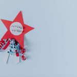 Red star with 'Future Voter' text and ribbons on a pastel blue background.