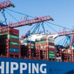 Dockerized Governance: Automating Compliance for Faster Shipping Shipping containers and cranes at Hamburg port showcasing global trade.