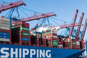Shipping containers and cranes at Hamburg port showcasing global trade.