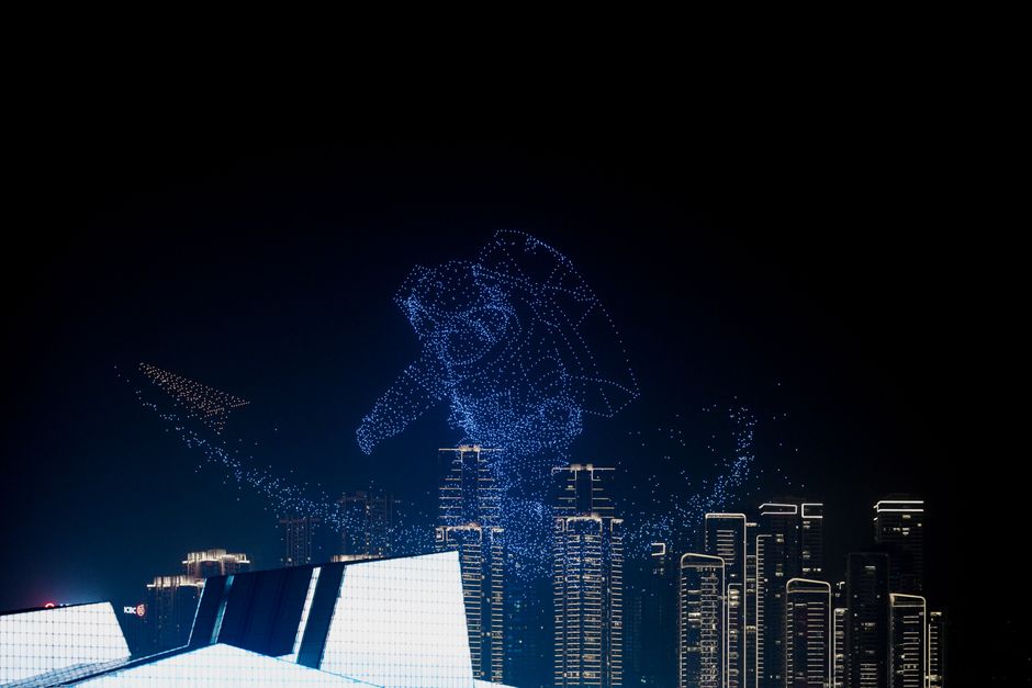 Breathtaking drone light show forming astronaut shape above city skyline, showcasing innovation.