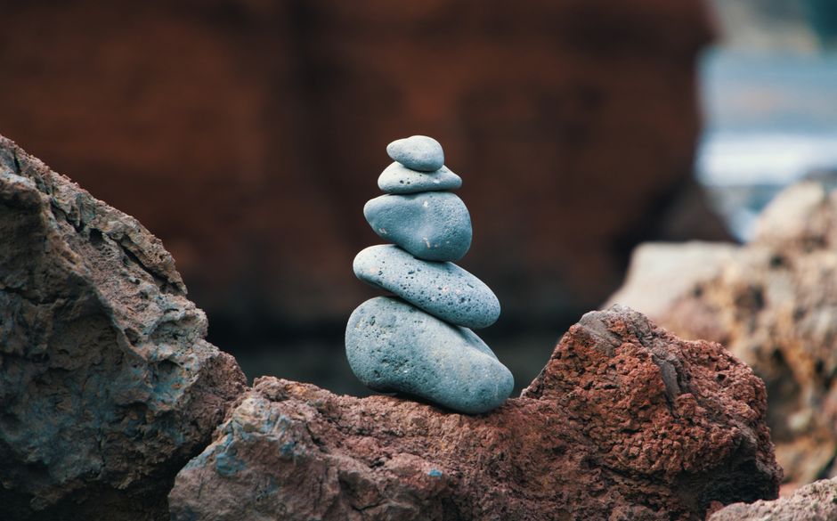 Peaceful arrangement of balanced stones in an outdoor rocky setting, symbolizing harmony.