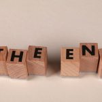 Wooden blocks arranged to spell 'The End' on a simple beige background, symbolizing closure.
