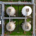 Drone aerial view of industrial silos and pipelines in Banten, Indonesia.
