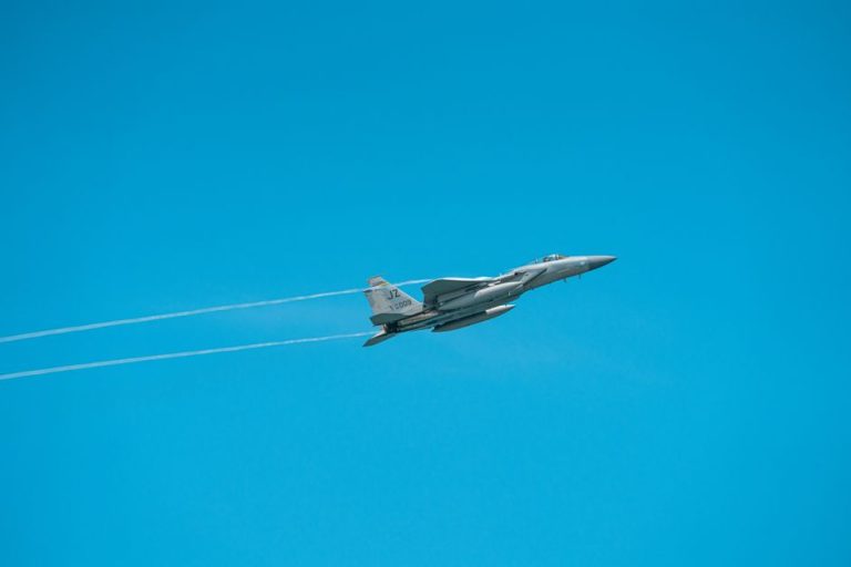 A military jet flies through a clear sky, showcasing agile aerial maneuverability.