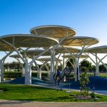 Unique modern playground structures in a sunny Qatar park.
