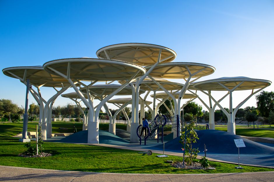 Unique modern playground structures in a sunny Qatar park.