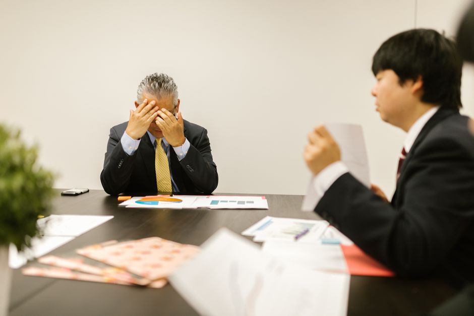 Professionals engage in a collaborative meeting, discussing business strategies.