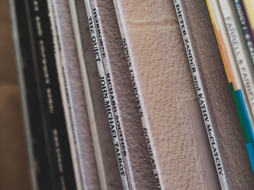 Detailed close-up of vintage vinyl records showcasing various album titles, perfect for music enthusiasts.