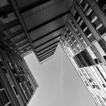 Black and white photo of futuristic skyscrapers with a dynamic perspective.